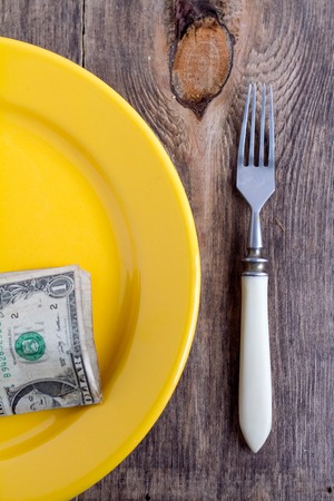 yellow plate and money.の写真素材