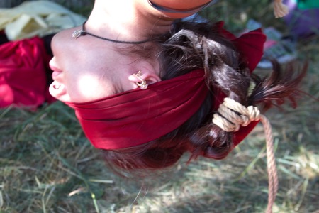Shibari in nature in summer. Bound young girl.の写真素材