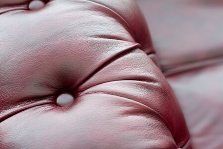 Closeup texture of vintage red leather sofa for backgroundの写真素材