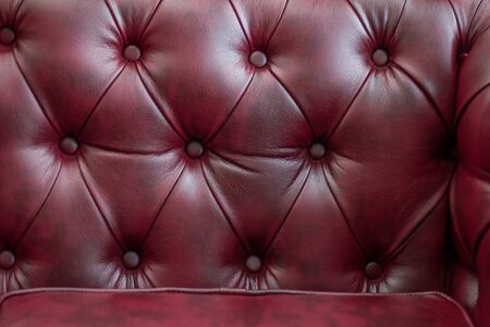 Closeup texture of vintage red leather sofa for background