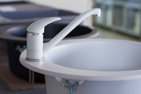 Modern kitchen and bathroom water faucets in the storeの写真素材