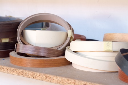 Furniture accessories. Multicolored bobbins of PVC edge and melanin for the manufacture of...