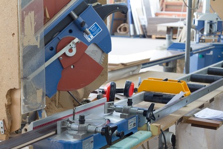 Industrial circular saw and vertical cutter in workshop.の写真素材