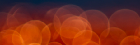 Abstract red bokeh on a black background. Defocused.の写真素材