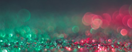 abstract defocused round shaped green and red lights on black background