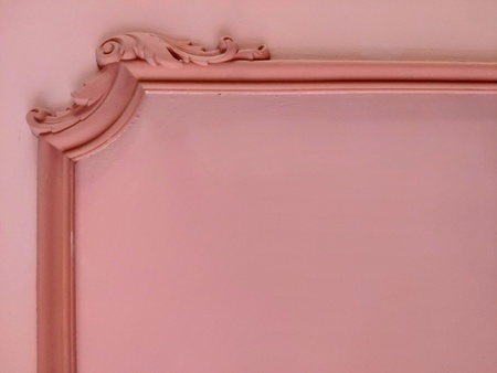 Background of coral color with elements of vintage plaster molding and moldings, free space for...