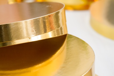 Gold and white coasters for cakes, rings for decorating cakes, baking tools, selektive focusの写真素材