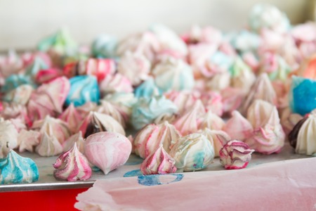 Pattern with meringues on a white background. Multicolored meringues on a white background. Meringue background.の写真素材