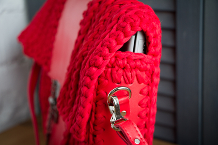 Extreme close-up of a handmade knitted bag in detail. Large red laptop briefcase. Selective soft focus.の写真素材