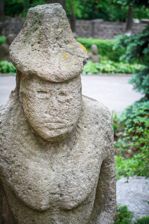 Ancient statue of Polovtsian stone woman or boundary stone in the city park, open-air museumの写真素材