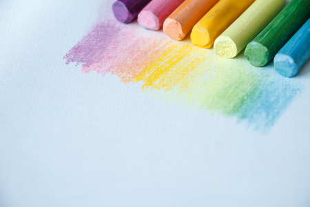 Close up view of the colorful chalk pastels on the white background, soft focusの写真素材