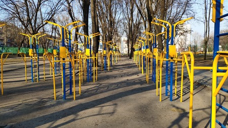 Yellow-blue exercise equipment located on the street for sports, fitness, street workout concept.