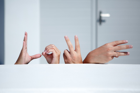 The hands of newlyweds make fingers with the word love, background or conceptの写真素材