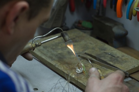 KHARKIV, UKRAINE - January 31, 2019: The master jeweler holds the working tool in his hands and...