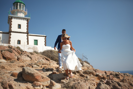 Greece, Santorini, Oia. September 16, 2014: a couple of newly married people in beautiful attire enjoying their honeymoon months in Greece.のeditorial素材