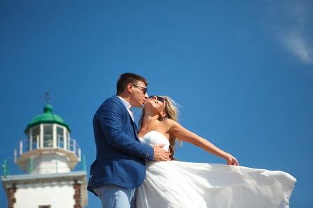 Greece, Santorini, Oia. September 16, 2014: a couple of newly married people in beautiful attire enjoying their honeymoon months in Greece.のeditorial素材