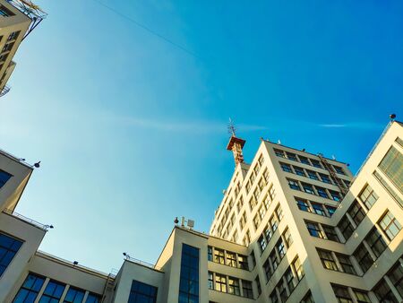 View up of State Industry Building or Gosprom built in Construction Art over blue sky, sun ray in...