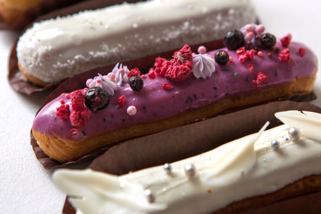 Set of several eclairs with various fillings and design isolate on a white background, the concept of French cuisineの写真素材