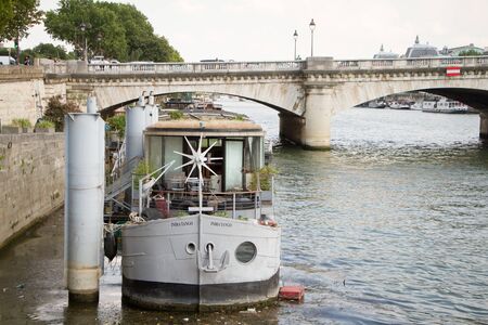 Paris, France - July 06, 2018: Residential barge on the river Seine moored near the Pont de la Concorde in Parisのeditorial素材