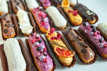 Set of several eclairs with various fillings and design isolate on a white background, the concept of French cuisine, copyspaceの写真素材