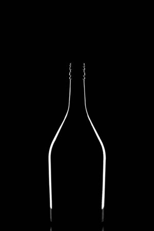 A stylish silhouette of elegant black corked wine bottle reflected and outlined by light on black backgroundの写真素材
