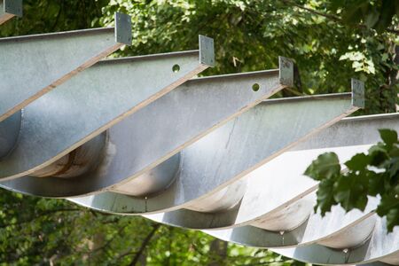 Closeup of metal supports for the construction of a hanging bridge or viaduct in a city park of rest