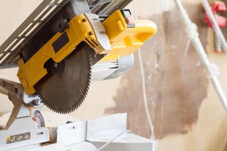 Closeup stationary circular saw on a carpentry table on a blurred background of a carpentry...