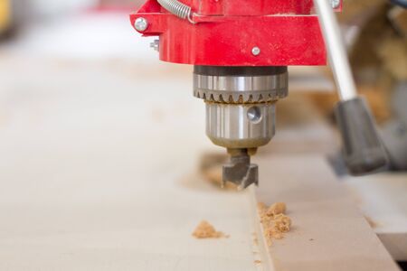 Close-up of the head of the drilling machine with nozzle in the furniture workshop, selective focusの写真素材