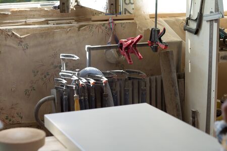 Many different joinery tools in a furniture workshop, selective focus