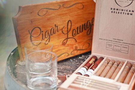 Schioss Wartholz, Austria - June 14, 2014: Close-up box with several sorts of cigars and small glasses for drinks, selective focusのeditorial素材