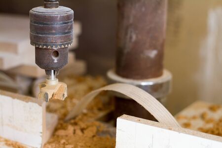 Close-up of the head of the drilling machine with nozzle in the furniture workshop, selective focusの写真素材