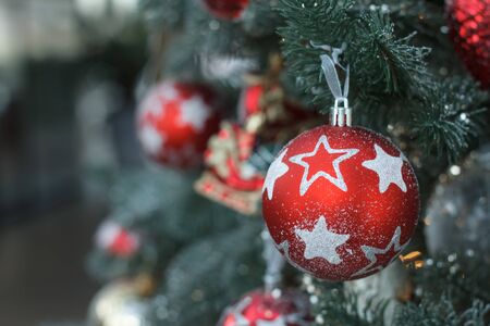 Close up white and red christmas balls with a golden garland on christmas tree branches, selective focusの写真素材