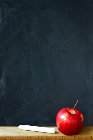 Close up black chalk board in chalk stains chalk board and red apple, selective focus, copyspaceの写真素材