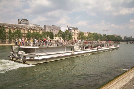 Paris, France - July 07, 2018: Ship with tourists sailing on the Seine on a study tour of Parisのeditorial素材