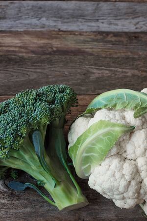 Fresh farmer green broccoli and cauliflower head on old rough wooden surface, healthy eating concept, selective focusの写真素材