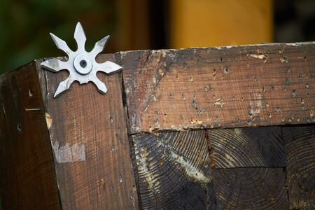 Close up throwing board for throwing star decorated with broken shurikens, selective focusの写真素材