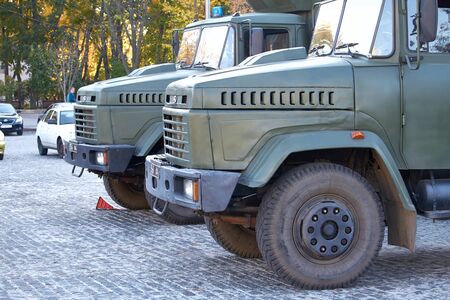Kharkiv, Ukraine - October 14, 2019: Two military trucks keep order during events in a city parkのeditorial素材