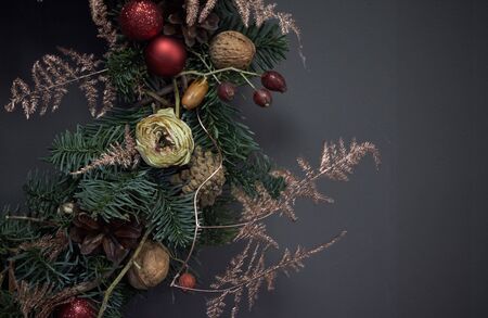 Detail close up Christmas wreath made of vines decorated with fir branches, Christmas balls and...