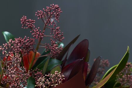 Detail close up chic autumn bouquet in red colors in vintage style on a dark background, selective focusの写真素材