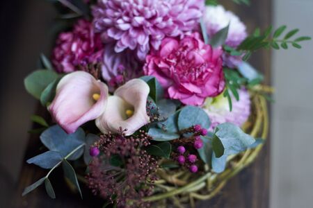 An autumn floral arrangement in vintage style in a wicker basket, selective focusの写真素材