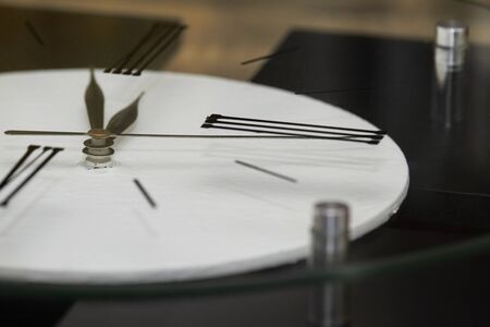 Extremely close up black clock hands on a white dial, selective focusの写真素材