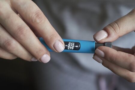 Scale window on pen syringe showing number of units dose. Medical equipment is easy to self injectionの写真素材