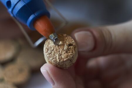 Homemade wine cork panel, woman makes wine cork note board, selective focusの写真素材