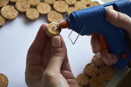 Homemade wine cork panel, woman makes wine cork note board, selective focusの写真素材