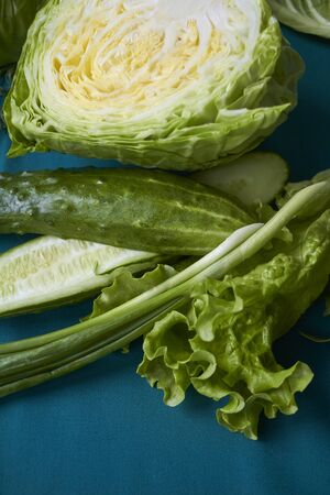 Closeup of fresh green vegetables on green tablecloth, selective focusの写真素材