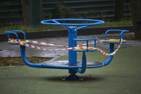 Empty playground without children with striped red and white warning tape, limitations quarantined for Covid19 coronavirusの写真素材