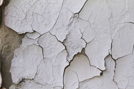 Old flaky cracked paint on grey wall, old paint background, selective focusの写真素材