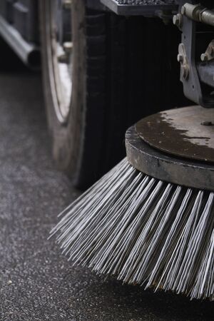 Closeup sweeper machine cleaning. Concept clean streets from debris. Selective focus.の写真素材