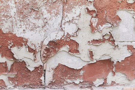 Old flaky cracked paint on grey wall, old paint background, selective focusの写真素材
