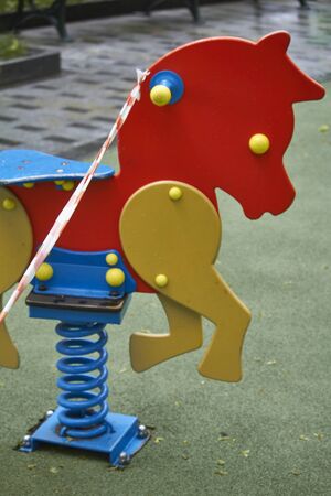 Empty playground without children with striped red and white warning tape, limitations quarantined for Covid19 coronavirusの写真素材